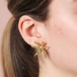 Close up of Oversized Sea Flower Stud Earrings in Gold on model