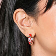 Close Up of Red Cloisonné Hoop Earrings in Silver on Model