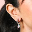 Close Up Of Model Wearing Millefiori Flower Bead Twisted Drop Huggie Hoop Earrings in Silver