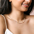 Pastel Semi-Precious Stone Beaded Necklace in Gold on model smiling against beige coloured backdrop