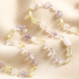 Pastel Semi-Precious Stone Beaded Necklace in Gold laid on top of neutral coloured fabric