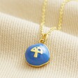 Blue Enamel Organic Mushroom Pendant Necklace in Gold on Beige Fabric