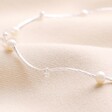 Close up of details on Freshwater Pearl Two Way Necklace and Bracelet in Silver against beige fabric