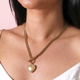 Close up of Gold Stainless Steel Chunky Toggle and Heart Pendant Necklace on model