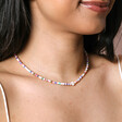 Multicoloured Heishi and Daisy Charm Beaded Necklace in Gold on model smiling