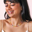 Multicoloured Daisy Beaded Necklace in Gold on Smiling Model