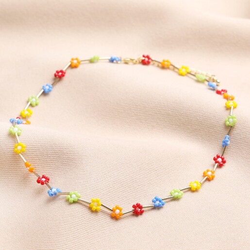 Multicoloured Daisy Beaded Necklace in Gold on Pink Fabric
