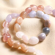Close up of Chunky Semi-Precious Stone Beaded Necklace arranged on top of beige fabric
