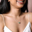Green Semi-Precious Stone Ball Pendant Necklace in Silver on Model Smiling Against Neutral Backdrop