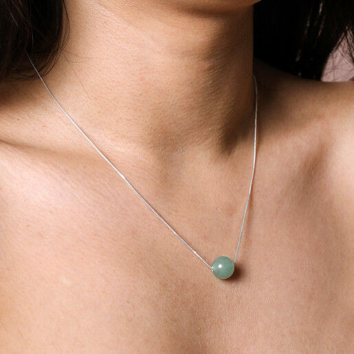 Close Up Necklace Worn Long on Model Close up of Green Semi-Precious Stone Ball Pendant Necklace in Silver Worn Long on Model