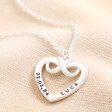Personalised Sterling Silver Infinity Heart Pendant Necklace with blackened engraving against neutral material