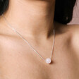 Close up of Pink Semi-Precious Stone Ball Pendant Necklace in Silver on model