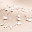 Dainty Flower Charm Necklace in Silver on Beige Fabric
