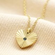 Gold Stainless Steel Crystal Antiqued Heart Pendant Necklace on top of beige coloured fabric