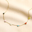Gold Stainless Steel Rainbow Enamel Tiny Heart Charm Necklace on Beige Fabric