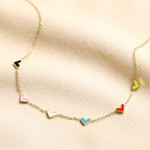 Gold Stainless Steel Rainbow Enamel Tiny Heart Charm Necklace on Beige Fabric