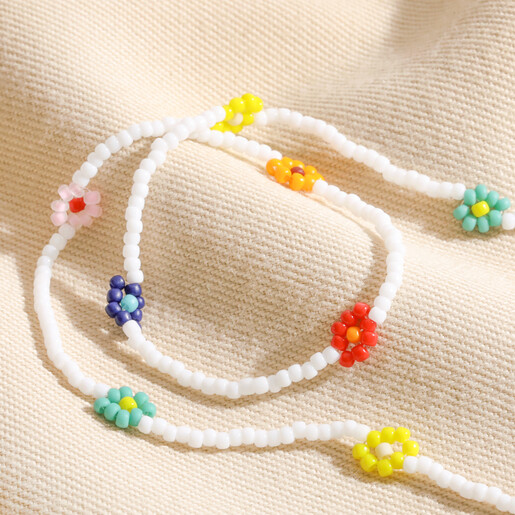 Colourful Daisy White Beaded Necklace Colourful Daisy White Beaded Necklace on top of neutral coloured fabric