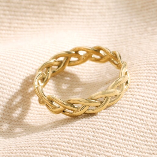 Gold Stainless Steel Braided Band Ring on top of beige coloured fabric