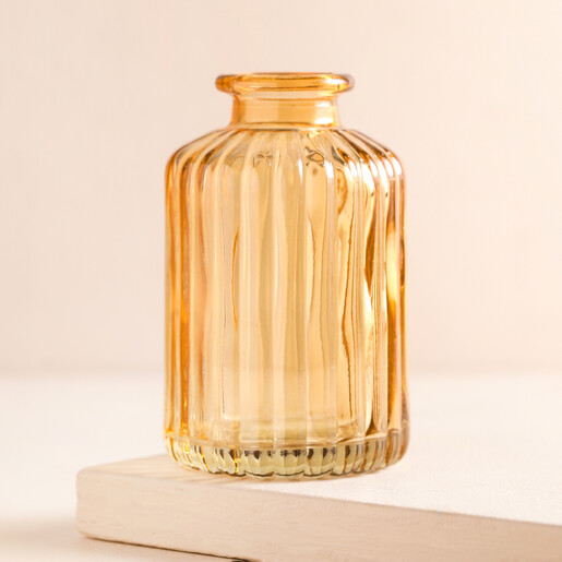 Empty Amber Ribbed Glass Vase Empty Amber Ribbed Glass Vase on a beige background