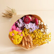 Bright Market Style Dried Flower Bouquet laid on top of neutral coloured backdrop