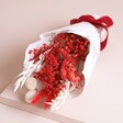 Close up of Red and White Valentine's Dried Flower Posy on top of neutral coloured backdrop