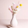 Summer Sunshine Dried Flower Posy arranged inside of vase against beige backdrop