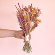 Model holding Betty Dried Flower Bridesmaid Wedding Posy in front of neutral background
