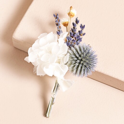 Lavender Dried Flower Wedding Buttonhole on top of pink backdrop