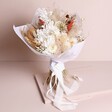 Nancy Dried Flower Bridal Wedding Bouquet wrapped in paper standing against neutral background