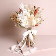 Nancy Dried Flower Bridal Wedding Bouquet unwrapped standing against neutral backdrop