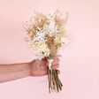 Model holding Nancy Dried Flower Bridesmaid Wedding Posy against neutral coloured backdrop
