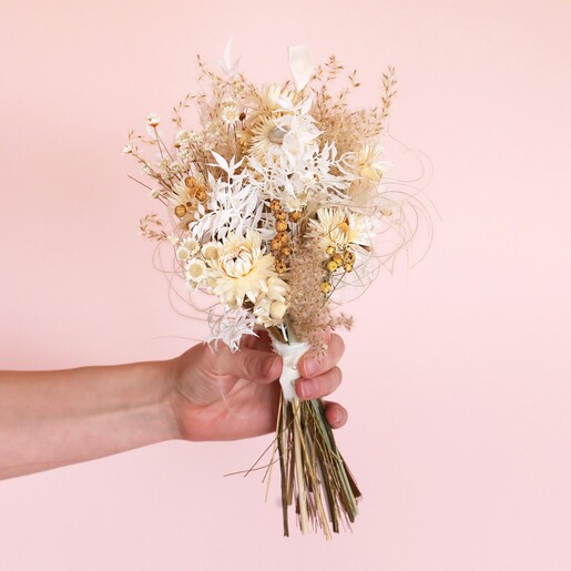 Model holding Nancy Dried Flower Bridesmaid Wedding Posy against neutral coloured backdrop