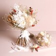 Nancy Dried Flower Wedding Buttonhole next to bridal bouquet and bridesmaid posy