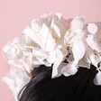 Close up of White Hydrangea Dried Flower Wedding Headband on model