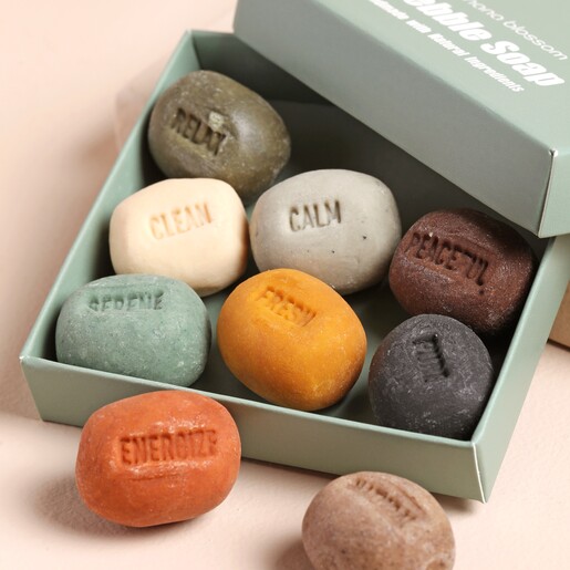 Close Up of Hana Blossom Mood Pebble Soaps on Pink Surface