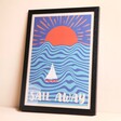 Wall Chart Sail Away Print A3 Framed Against Beige Surface