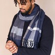 Navy Striped Winter Scarf on model in front of neutral backdrop