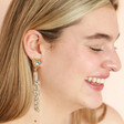 Model smiling wearing My Doris White Beaded Love Drop Earrings