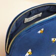 Close up of Small Navy Velvet Bee Wash Bag open showing lined interior