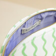 Close up of lilac interior inside of Personalised Small Green Wavy Lines Wash Bag
