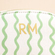 Close up of personalisation on Personalised Small Green Wavy Lines Wash Bag against neutral background