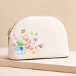 Small Pink Bee Floral Wash Bag on Beige Surface