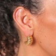 Close Up of Model Wearing Chunky Twisted Rope Half Hoop Earrings in Gold