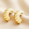 Chunky Twisted Rope Half Hoop Earrings in Gold on Beige Surface