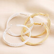Triple Layered Thread Hoop Earrings in Silver with gold version on top of beige material