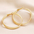 Triple Layered Thread Hoop Earrings in Gold against neutral coloured backdrop