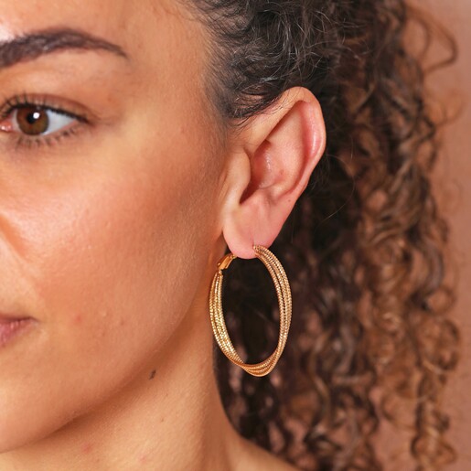 Close up of Triple Layered Thread Hoop Earrings in Gold on model