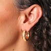 Close Up of Scattered Crystal Stars Chunky Hoop Earrings in Gold on Model
