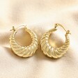 Twisted Rope Creole Hoop Earrings in Gold on top of beige coloured material
