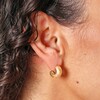 Close Up of Small Chunky Half Hoop Earrings in Gold on Model